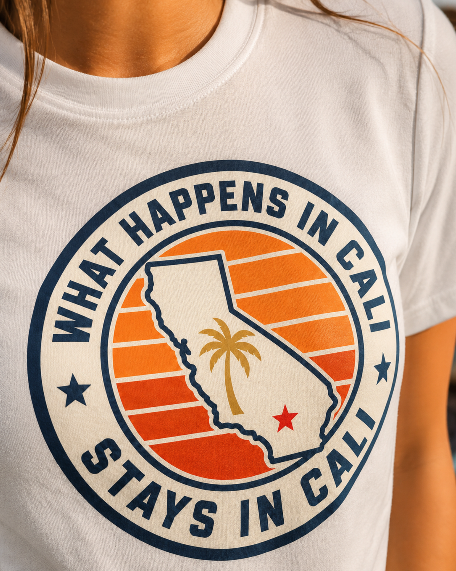 California Shirt – What Happens In Cali Sunset Badge Graphic Tee