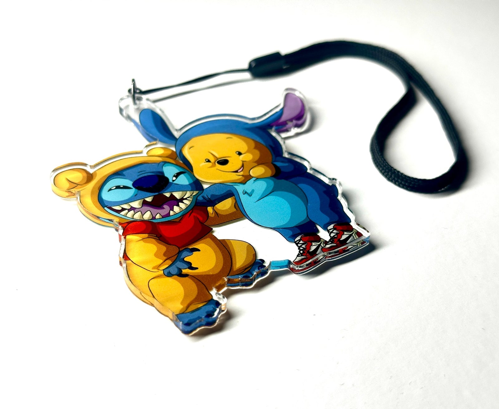Blue alien and honey bear costume mashup acrylic wrist strap keychain on white background, angled product photo
