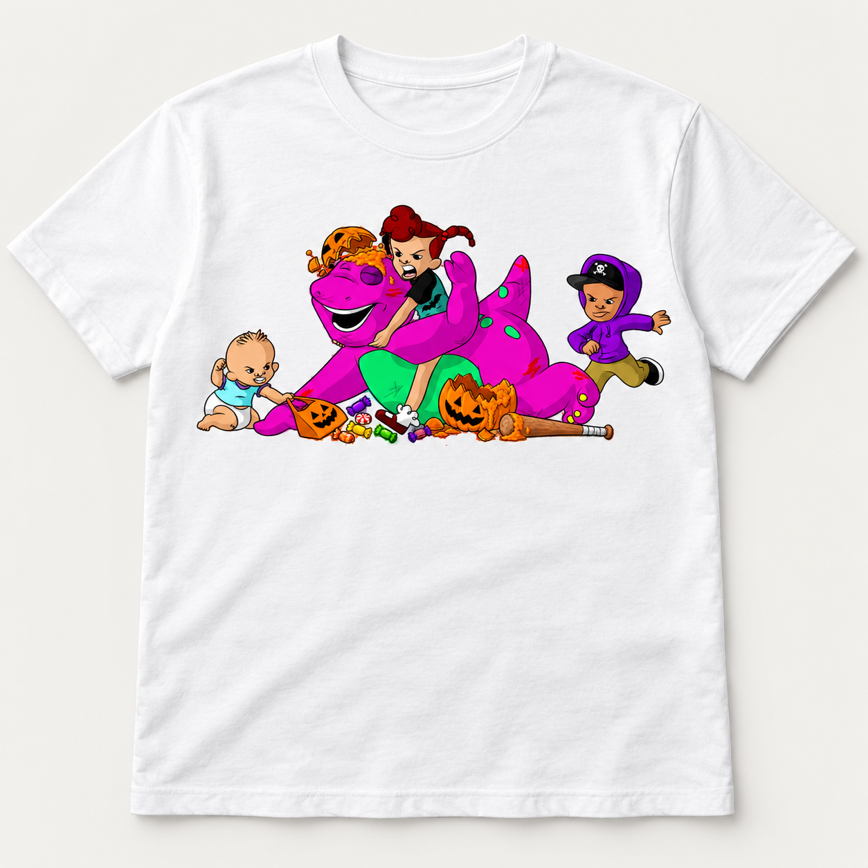 White graphic T-shirt showing cartoon kids stealing a purple dinosaur's candy with broken jack-o-lanterns and scattered sweets.
