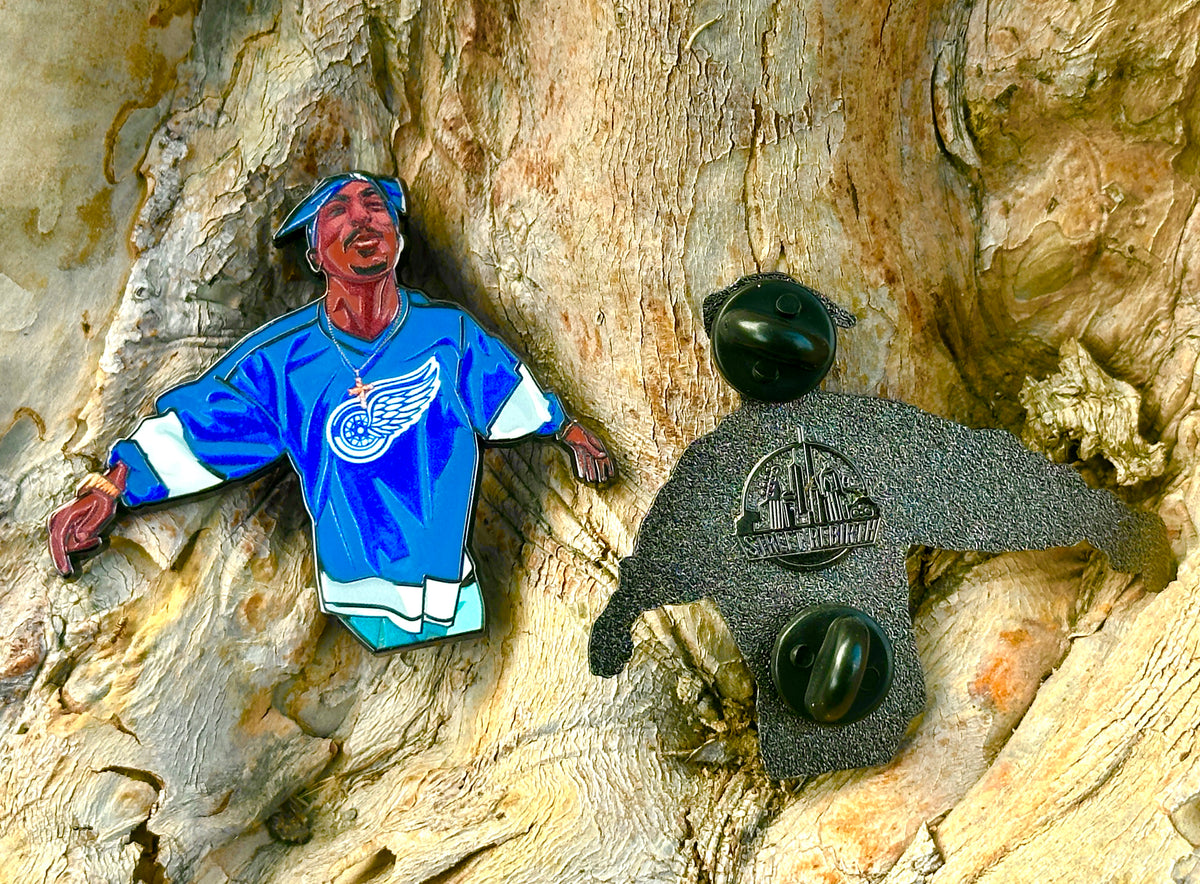 Tupac in Blue Jersey Iconic Spitting Moment Enamel Pin – A Powerful Tribute to a Legend
