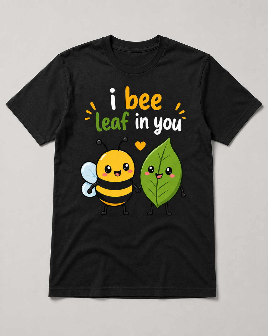 I Bee Leaf In You cute bee and leaf love pun graphic tee on a black shirt