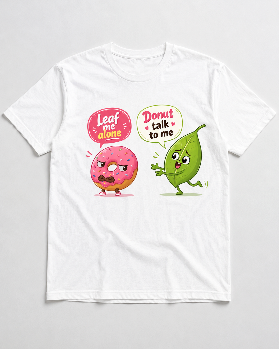 White graphic T shirt with funny leaf and donut pun design reading Leaf me alone and Donut talk to me
