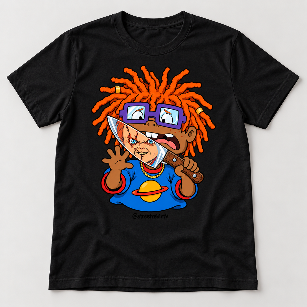 Black graphic T-shirt with a caramel-skinned cartoon boy, orange locs, purple glasses and a spooky doll face reflected in a knife