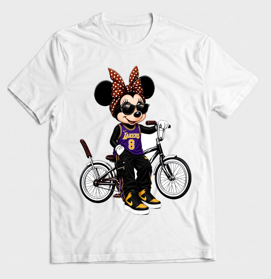 White graphic T-shirt featuring a cartoon mouse in a purple and gold basketball outfit with a brown polka dot bow and lowrider bicycle