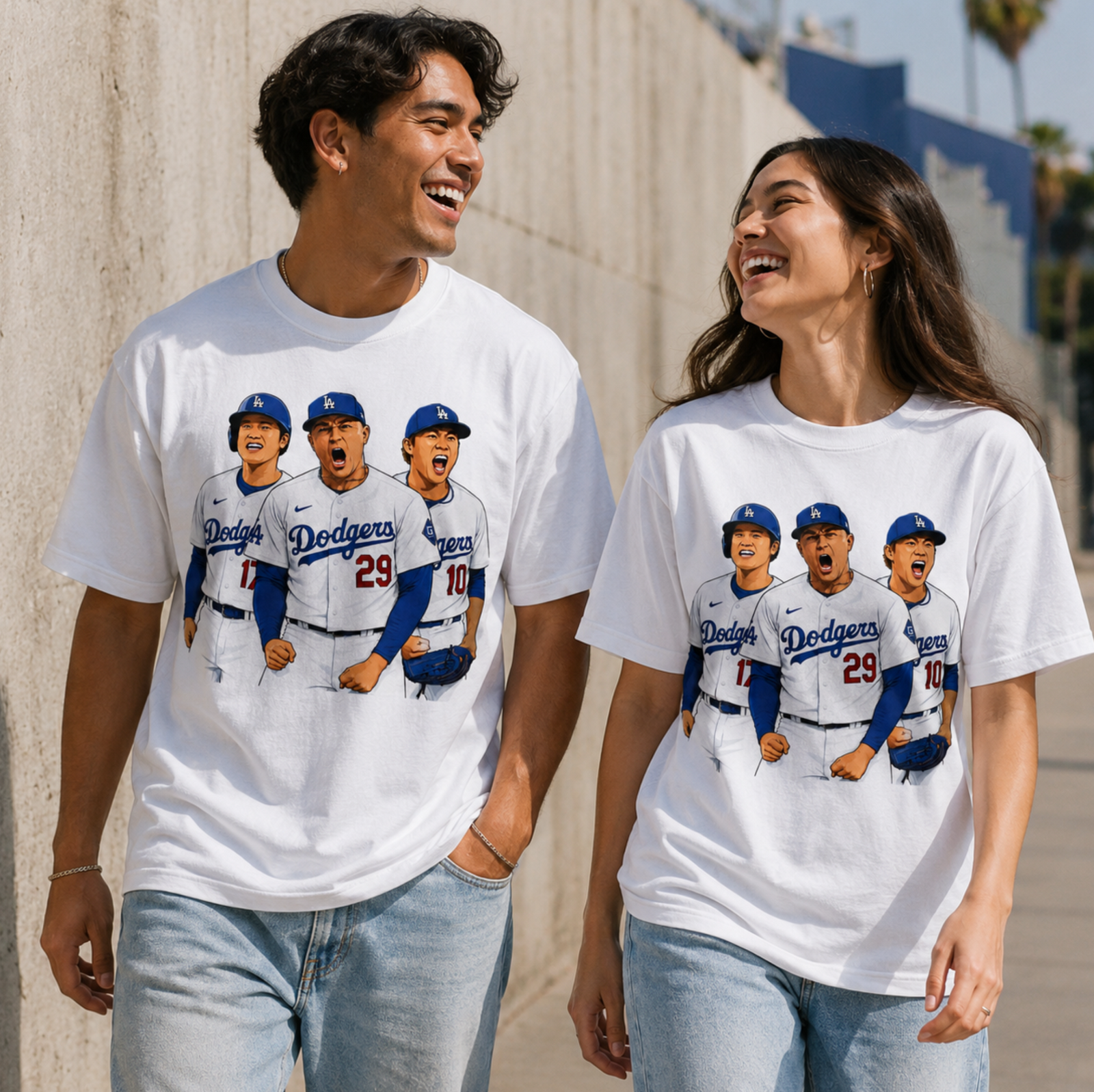Two models wearing matching white baseball trio graphic T shirts outdoors in a casual game day look.