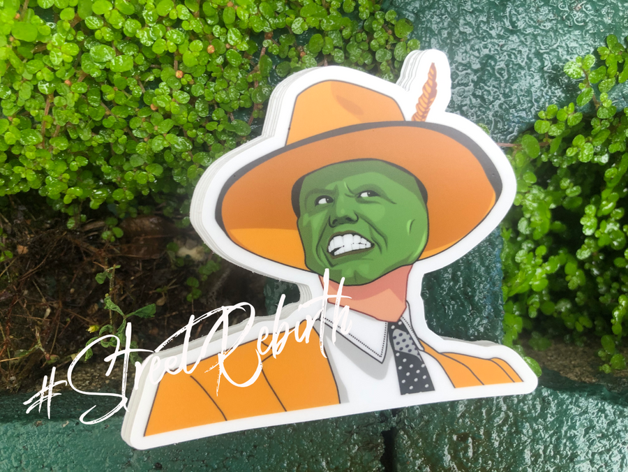 90s comedy sticker of a green faced character in an orange zoot suit and wide brim hat